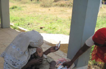 Sadun being treated with RUTF by his mother Fatuma